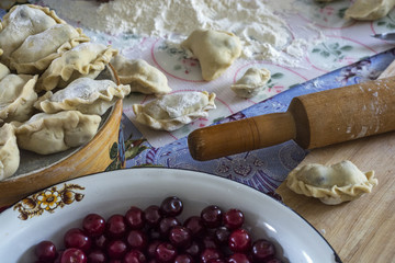 Fototapeta premium Cooking at home dumplings with cherries