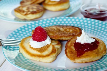 Pancakes  with fresh raspberries,berry jam and a little whipped cream