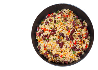 rice with red beans and vegetables in a frying pan. top view. isolated on white