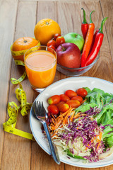 Healthy concept with mixed fruits and vegetables on wooden background