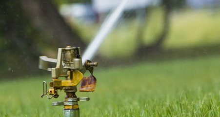 Automatic irrigation system on the background of green grass