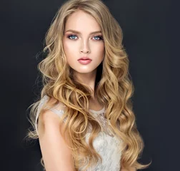 Papier Peint photo Salon de coiffure Blonde fashion  girl with long  and   shiny curly hair .  Beautiful  model  in light blue dress with wavy hairstyle .  