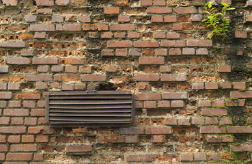 ventilation grates of the old brick wall