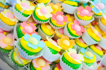 Cakes in paper baskets with flowers