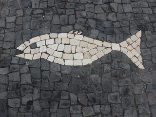 Naklejka premium Mosaic in the form of fish on the sidewalk. The island of San Miguel. Azores