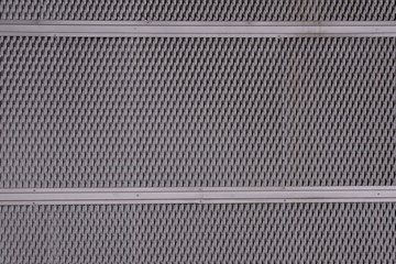 iron metal sheet plate cladding with perforated holes in a geometric pattern and a rust effect
