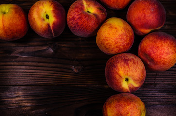 Fototapeta na wymiar Fresh ripe peaches on wooden table. Top view