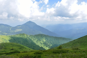 Fototapeta premium Clouds over mountains, mountain ranges, summer tourism