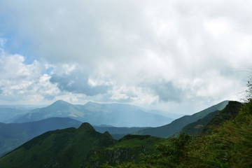Fototapeta na wymiar Clouds over mountains, mountain ranges, summer tourism