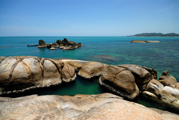 stone on blue sea coast