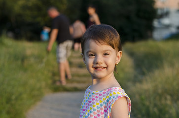 Small angel beauty with sparkling sunset in her eyes