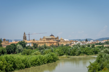 Fototapeta na wymiar The bell tower and Cathedral mosque of Cordoba from the bridge on the river Guadalquivir