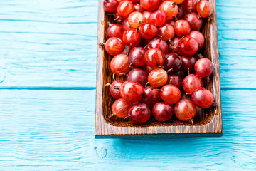 Red gooseberry in wooden cup