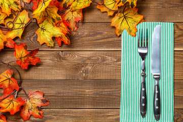 Wooden background with fork, knife