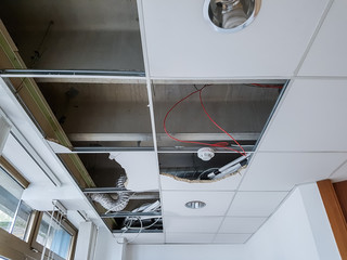 Ceiling panels damaged and collapsed by water.