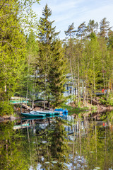 Boats near the forest shore of the lake in Karelia