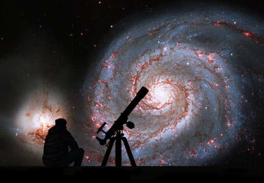Man with telescope looking at the stars. Whirlpool Galaxy. Spiral galaxy M51 or NGC 5194.