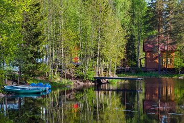 Boats near the forest shore of the lake in Karelia