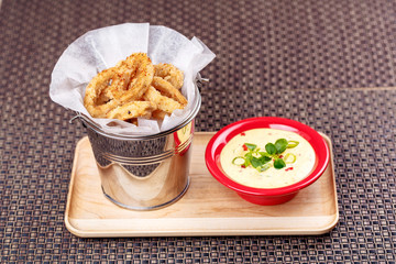 Deep Fried Calamari Rings on backet with Sauce Bowl