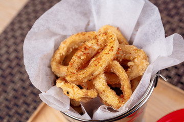 Deep Fried Calamari Rings on backet with Sauce Bowl