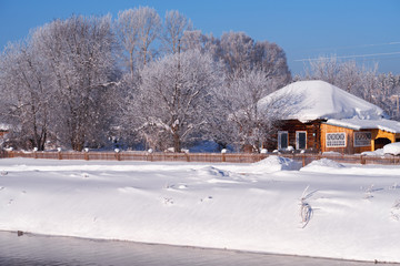 Altai russian country village Talitsa under winter snow on bank of river