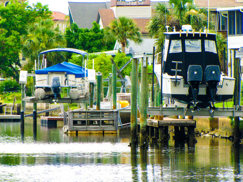 Ocean boats in canal on boat lifts in Florida