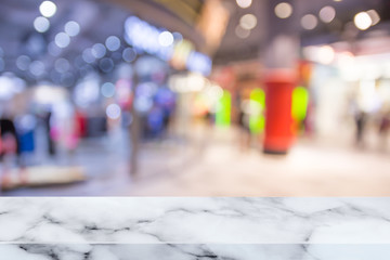 Empty top of marble table with blur shopping mall background.