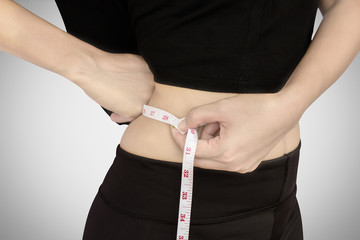 Woman with tape measure around waist.