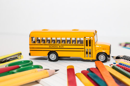 Yellow school bus toy with schools stationery supplies