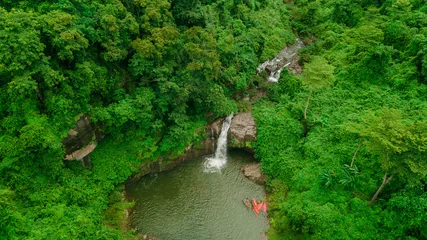 Foto op Canvas Waterfall in the middle of the forest. Bird eye view , drone © meen_na