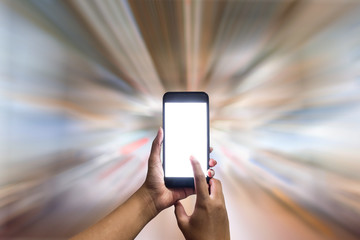 Hand holding a blank screen smart phone on the fast blurred background.