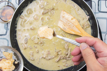 Chef putting cooconut palm sugar for cooking green curry