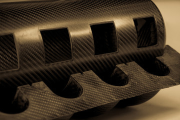 Black carbon fiber composite raw material product close up background