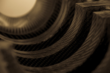 Black carbon fiber composite raw material product close up background