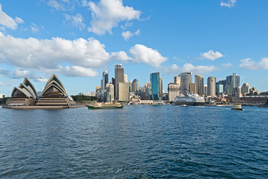 Sydney Australia city scape on blue sky clouds with opera house from harbour.
Sailing into Sydney at day break 