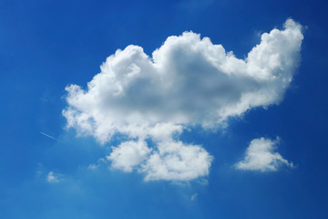 Fototapeta na wymiar One cloud on a bright blue sky background