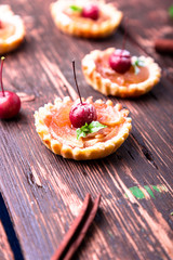 Apple caramel little tarts on brown rustic background. French tatin with paradise apple.