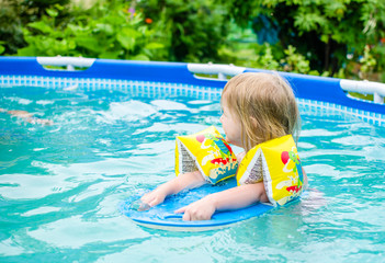 девочка купается в бассейне