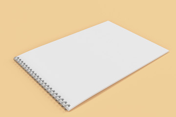 Blank white notebook with metal spiral bound on orange background