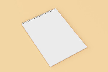 Blank white notebook with metal spiral bound on orange background