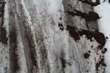 Groung melting snow mud dark gray brown