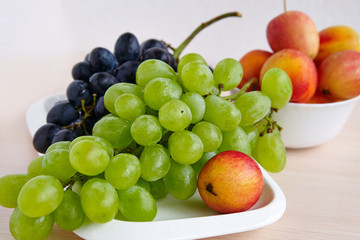 A bunch of white grapes on a white plate
