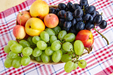 Grapes in a straw basket view from above.
