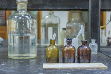 detail shot of beakers and equipment on table in factory laboratory.