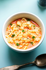 Homemade tomato soup with poured noodles - traditional Polish soup 
