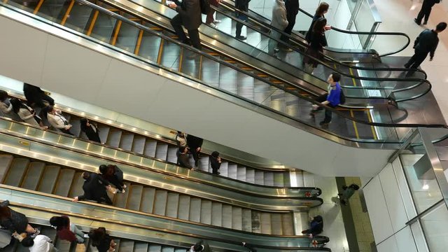 Hong Kong, March 2017 - :People on escalator in IFC shopping mall 