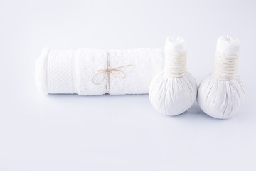 Fototapeta na wymiar White towel and herbal balls on a white background