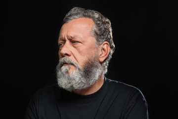 Obraz premium Handsome elderly man on black background
