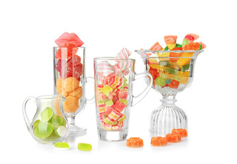 Colorful candies in glassware on white background