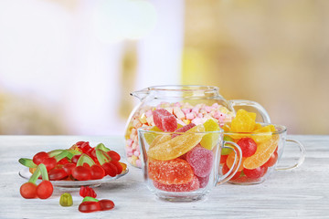 Glassware with colorful candies blurred background